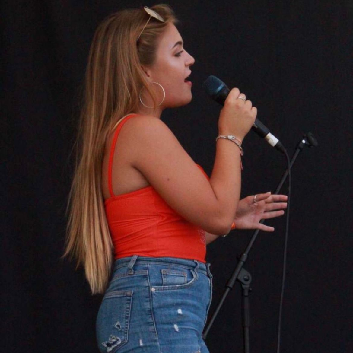 Lucy Armstrong singing live at an outdoor performance